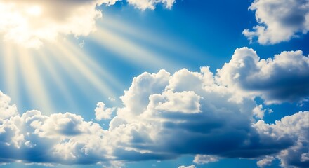 Sunbeams breaking through dramatic clouds on a bright blue sky