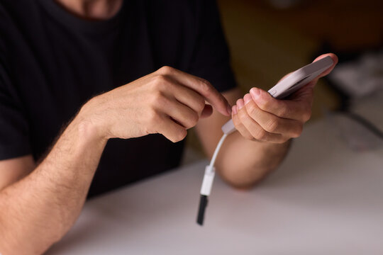 man using otg usb with her mobile phone to copy photos