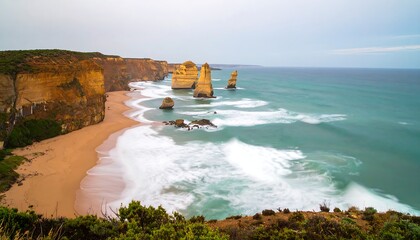 Coastal view of sandstone rock formations emerging from the ocean, waves crashing on a sandy beach