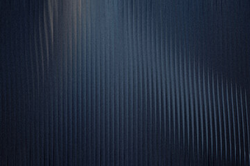 Obraz premium A dark blue textured background with vertical ribbed patterns and a subtle grainy effect, creating a sophisticated and abstract visual