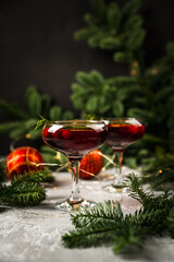 Cocktail based on gin with cranberry juice in christmas decorations. Cocktails for christmas party. 