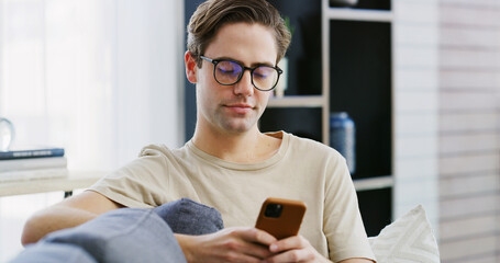 Home, relax and man on couch, cellphone and typing with social media, connection and message to...