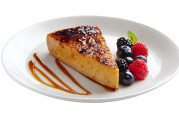 An elegant slice of crème brûlée cheesecake with a torched sugar crust. Served with fresh berries and caramel. A decadent and delicious gourmet dessert.