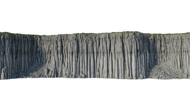 Tall, sheer grey cliff face with grass on top rock - Powered by Adobe