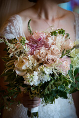 Bride Holding Lush Romantic Bouquet in Soft Lighting