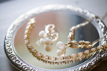 Golden Pearl Jewelry Reflected on Vintage Mirror