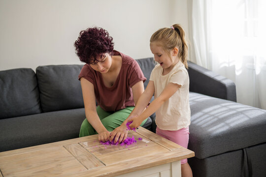 Girls kids playing with purple slime putty at home