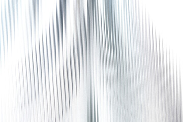 A shimmering silver fabric with vertical pleats and a subtle gradient, creating a sense of luxury...