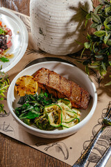 fried fish with lemon and green salad