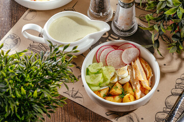 okroshka with potatoes, radishes and herbs