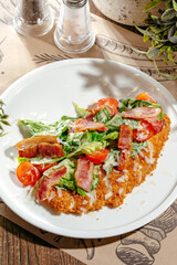 chicken schnitzel with salad and bacon
