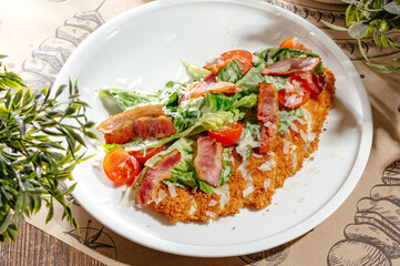chicken schnitzel with salad and bacon