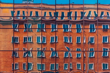 Reflection of an old building in the windows of a modern art