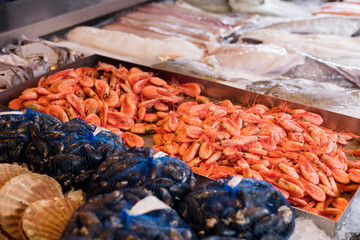 Market stall with assorted shrimp, fish and seafood on ice