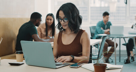 Fototapeta premium Creative, woman and typing with laptop in office for research, finance report and review budget. Female person, pc and coworking for financial planning, bookkeeping information and company investment