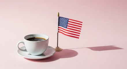 A steaming cup of coffee sits next to an American flag on a pink background, evoking patriotism and morning routines