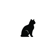 A black cat sitting in profile looking to the right side