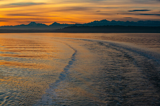 Boat wake from a Puget Sound ferry with view of the Olympic Mountains, Seattle, WA USA
