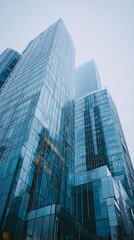 Fototapeta premium LowAngle View of Blue Glass Skyscrapers on a Cloudy Day