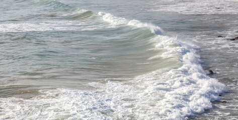 The ocean is calm and the waves are small