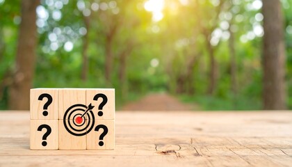 Wooden blocks with question marks and a target sit on a table, a blurred forest path background