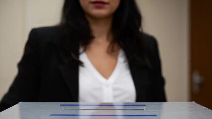 A Woman Engaging in the Voting Process, Casting Her Ballot with Confidence and Commitment to Democratic Participation