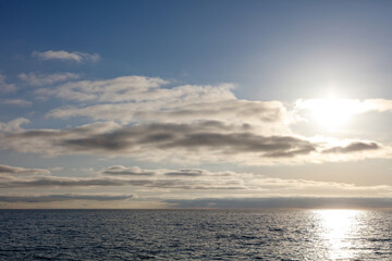 The sky is clear and the sun is shining on the water