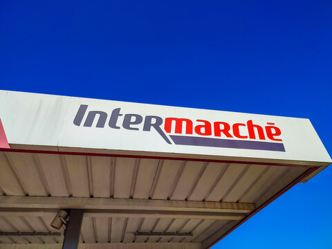 Intermarche supermarket sign against a clear blue sky showcasing brand identity and vibrant colors
