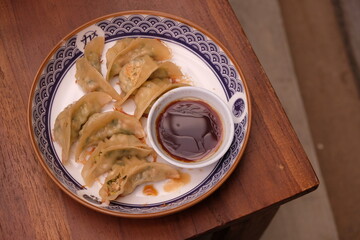 Gyoza are dumplings filled with minced meat and vegetables, wrapped in a thin dough. Also known as potsticks, gyoza originate from China (where they are called jiaozi). Japanese food