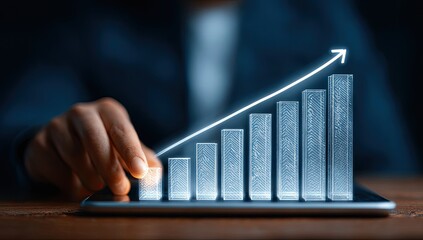 Hand interacting with glowing bar graph on tablet