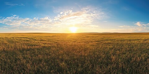 Wide open prairie with sun emerging from distant horizon Stock photo