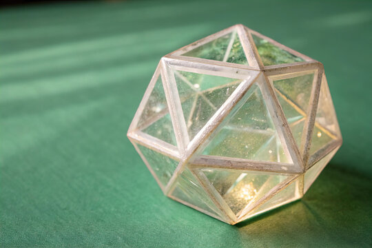 ranslucent Geometric Crystal Cube on Green Background