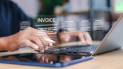 Businessman using laptop with digital invoice document interface. Online billing, e-invoice, financial management, accounting, fintech and paperless business concept.