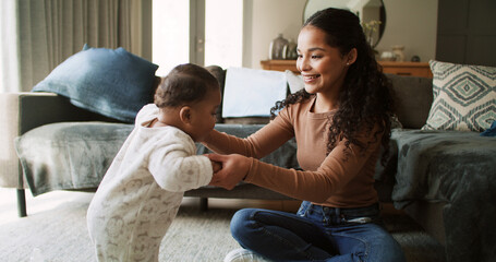Home, holding hands and mother with baby, help and bonding together in living room. Apartment, family and happy mama with kid, support and child development with steps, growth or learning with parent