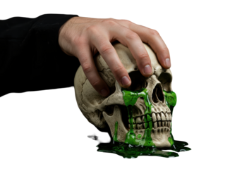 Isolated human skull gripped by hand with green liquid flowing, Halloween horror theme