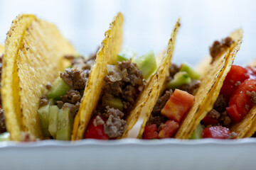 Close-up of Mexican-style tacos with ground meat and vegetables