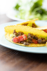 Close-up of Mexican-style tacos with ground meat and vegetables