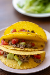 Close-up of Mexican-style tacos with ground meat and vegetables