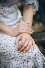 A girl is resting peacefully on a chair in the park, enjoying the calm atmosphere of nature.
