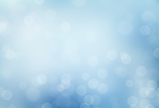 light blue winter blurred background with defocused lights or bokeh