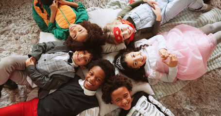 Halloween, above and kids on floor, portrait and relax with celebration, event and bonding...