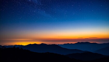 Naklejka premium Twilight mountain landscape with silhouetted ridges and starry sky transitioning to vibrant sunrise hues.