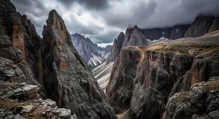 A rocky landscape is shown with sharp cliffs and detailed rock textures under a cloudy sky. Nature concept