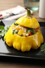 Tasty stuffed pattypan squash on wooden table, closeup