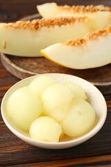 Cut ripe melon on wooden table, closeup