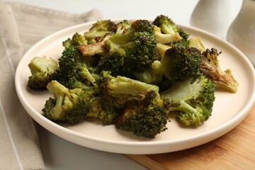 Tasty fried broccoli on white table, closeup
