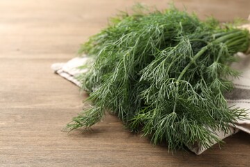 Bunch of fresh dill on wooden table, closeup