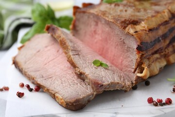 Delicious baked beef meat and spices on table, closeup