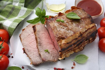 Delicious baked beef meat, tomatoes, spices and water with lime on table, above view