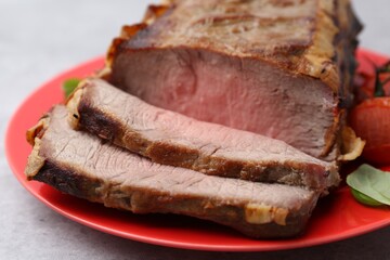 Delicious baked beef meat on grey table, closeup